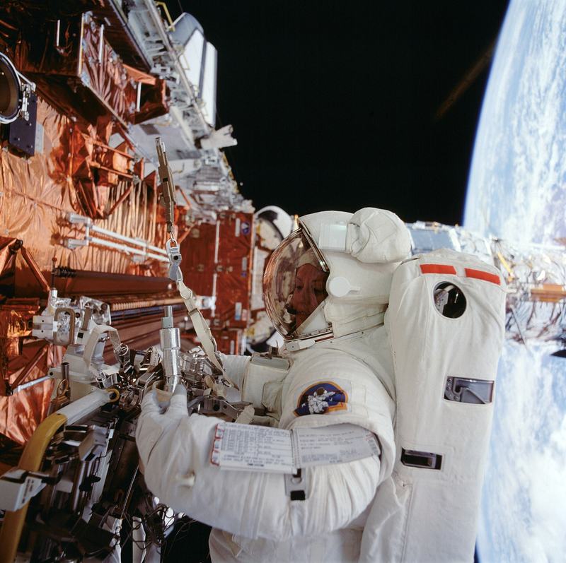 Astronaut Kathryn Thornton working on Hubble during a servicing mission spacewalk