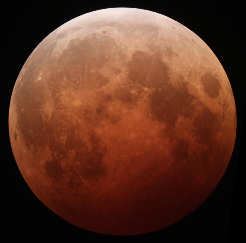 The Moon glowing deep red near the peak of a total lunar eclipse