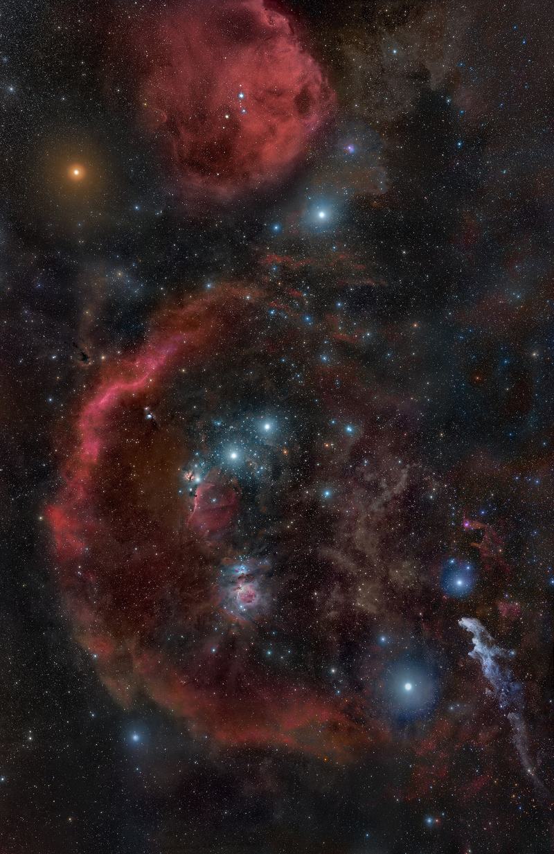 The full Orion constellation with its surrounding nebulae in a wide-field photograph