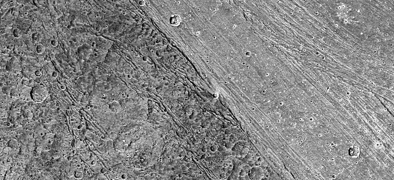 Boundary between dark, heavily cratered terrain and lighter grooved terrain on Ganymede, imaged by Galileo